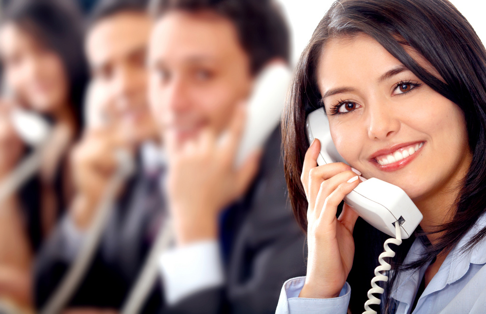 customer support team lead by a friendly girl smiling in an office